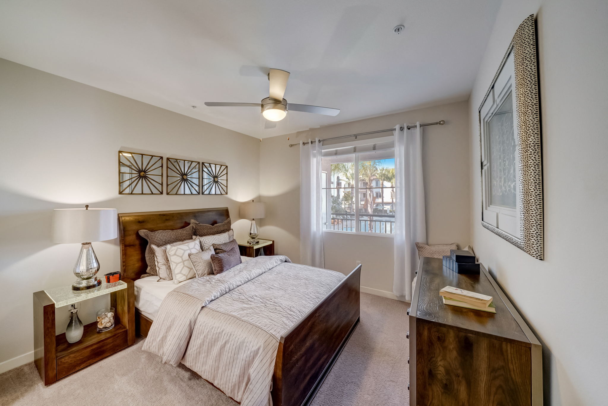 a bedroom with a bed and a ceiling fan